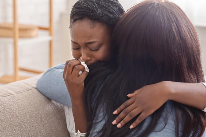 Woman consoling grief-stricken friend
