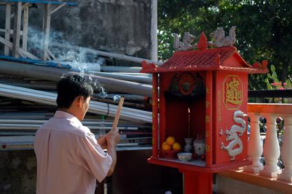 Praying in front of urns.