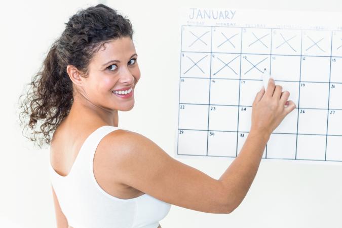 Pregnant woman marking calendar