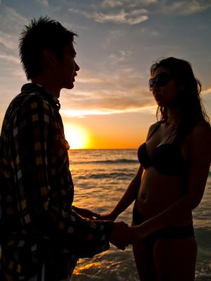 Romantic couple enjoying sunset at the beach