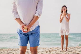Man making propose to his girlfriend at the beach