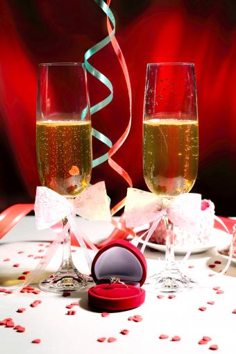 Glasses of champagne with the ring in gift box