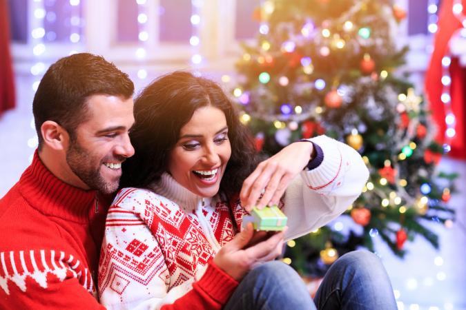 Young man surprising girlfriend on Christmas