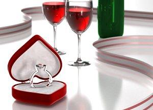 Wine and engagement ring in heart-shaped box