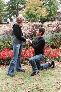 Couple getting engaged in a garden