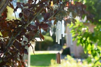 Campana de viento de metal colgada en un árbol