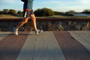 Fit man jogging by beach