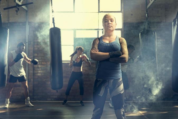 Confident woman standing in gym