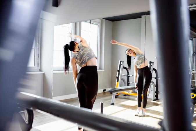 Woman stretching in front of mirror