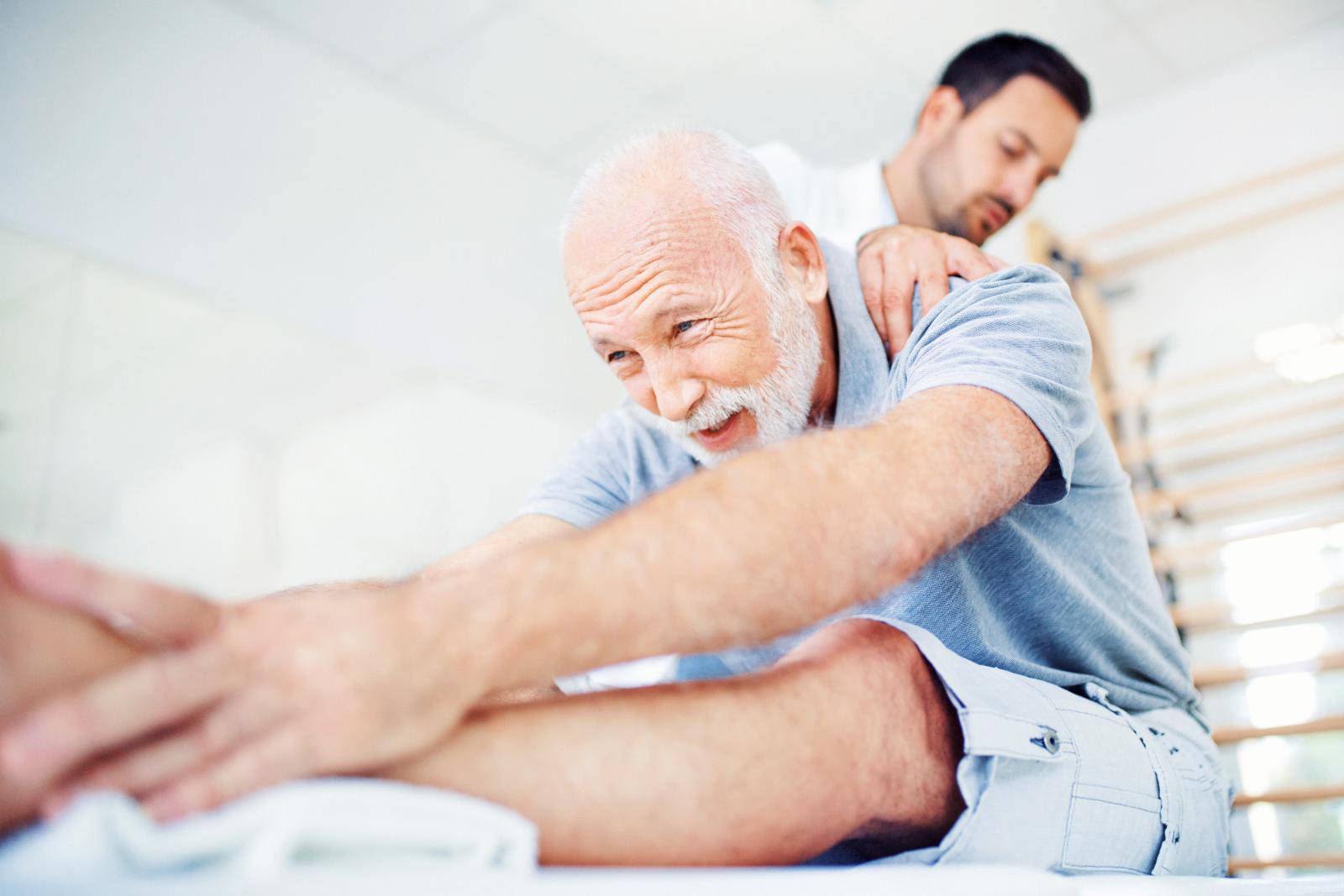 Senior gentleman having some back pain and a doctor
