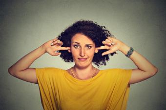 Woman plugging ears with fingers