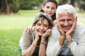 Young girl in park with grandparents