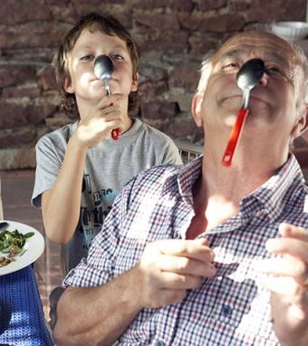 Grandfather and grandson playing with spoon