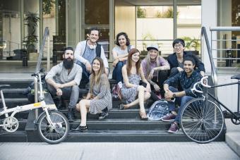 Group of creative colleagues sitting together outdoors