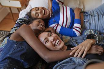 Best friends lying on bed at home