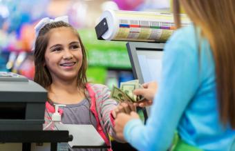 Little girl paying for purchases 