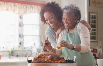 mother and daughter preparing turkey 