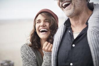 Happy father with adult daughter on the beach 