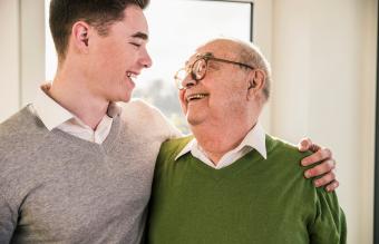 Senior man smiling at young man