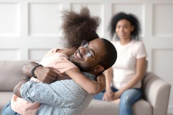 Happy dad embracing daughter