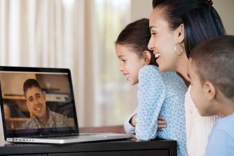 family having video chat with military father