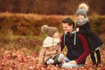 Happy Family In Autumn Park Outdoors