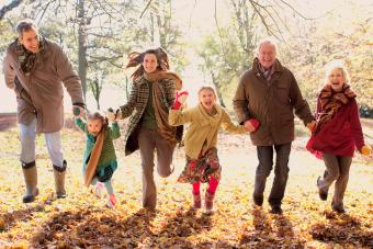 Extended family running in park in autumn