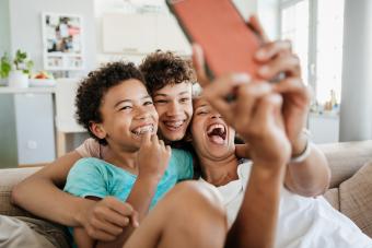 Mom Having Fun With Her Sons Watching Smart Phone