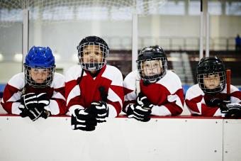 Young ice hockey players in players box