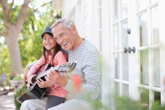 Grandparent granddaughter playing guitar