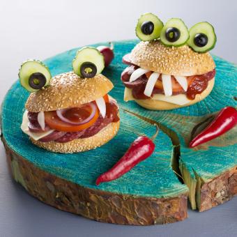 Monster hamburgers close up with red chili peppers