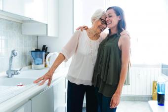 Smiling granddaughter and grandmother hugging