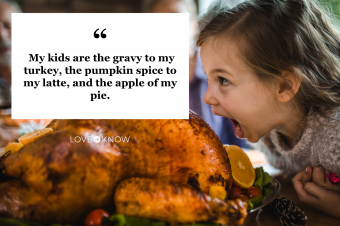 Small girl having fun while about to bite a roasted turkey on Thanksgiving