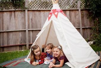 toddlers in tent camping in backyard