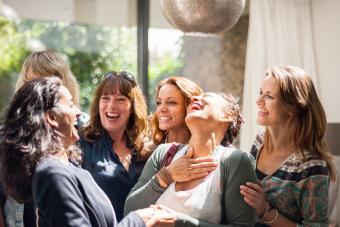 Women at reunion greeting and smiling