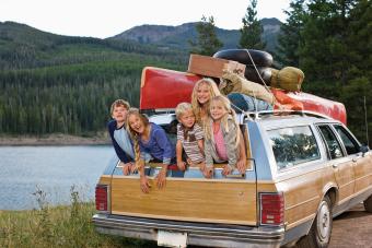 Kids hanging out of back of station wagon 