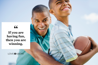 Father and son having fun while playing football