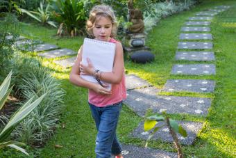 girl with notebook on nature scavenger hunt