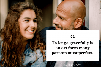 Smiling teenager looking at father while talking outdoors 