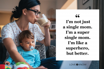 Young single mother with a baby using laptop at home