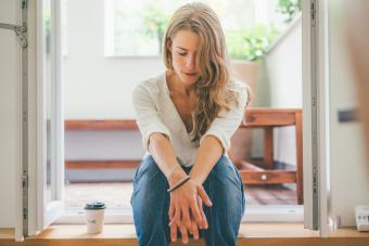 woman sitting on steps thinking and trying to forgive