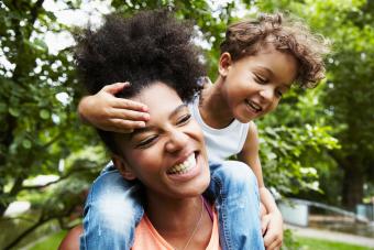 Gender neutral parenting parent with child in park