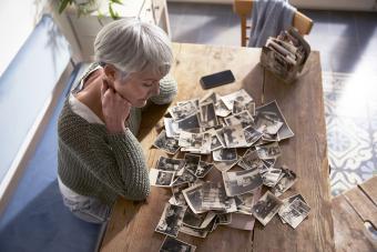 Woman looking at old photos at home