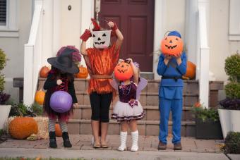 Children covering face with Jack O Lantern