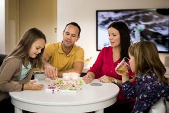 Family playing ludo in living room 