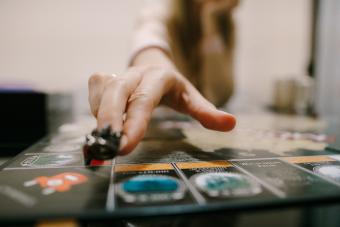 Woman Hand Playing Monopoly