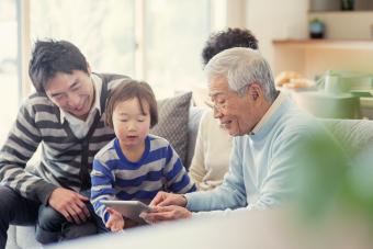 Family using digital tablet together at home