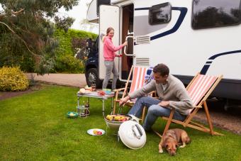 Couple RV Camping and cooking with their dog