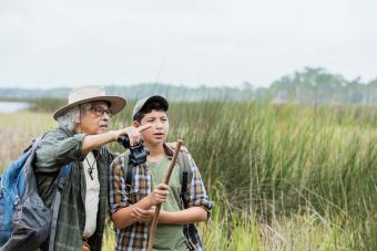 boy hiking with grandfather, bird watching