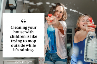 Two sisters splashing with window cleaner